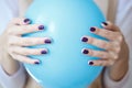 Gorgeous manicure, dark purple tender color nail polish, closeup photo. Female hands over simple background Royalty Free Stock Photo