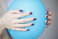 Gorgeous manicure, dark purple tender color nail polish, closeup photo. Female hands over simple background Royalty Free Stock Photo