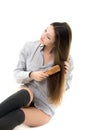 Gorgeous model combing her hair in shirt and spats Royalty Free Stock Photo