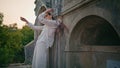 Gorgeous model posing ancient building leaning old wall. Woman posturing castle