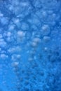 Gorgeous morning sky with bright blue background and puffy white cloud cover Royalty Free Stock Photo