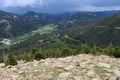 Stunning vista on roadway, with mountain range, valleys, green fields and clouds overhead Royalty Free Stock Photo