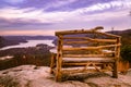 Gorgeous mountain and sunset landscape with wooden bench