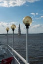 Kalyazin, Russia, July 3, 2023. Lanterns of the pier and a distant view of the bell tower.