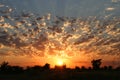 Gorgeous panorama scenic of the strong sunrise with golden lining and clouds on the orange sky Royalty Free Stock Photo