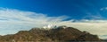 Gorgeous picturesque mountain ridge with snowy peak highland scenery landscape background view blue sky white clouds in clear