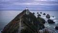 Gorgeous pink sunrise panorama at Nugget Point Lighthouse taken on a cloudy winter day, New Zealand Royalty Free Stock Photo