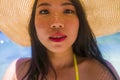 Gorgeous portrait of young happy and beautiful Asian Korean woman in Summer hat and yellow bikini enjoying exotic holidays at Royalty Free Stock Photo