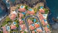 Gorgeous private villas with orange roofs and ocean views next to the beach. Aerial top down view of luxury oceanfront