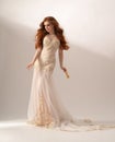 Gorgeous redhead woman posing in fashion long dress