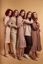 Gorgeous redhead women in trendy clothes posing hugging looking camera isolated Royalty Free Stock Photo