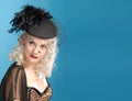 Gorgeous retro girl in forties hat with feathers