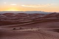 Gorgeous and scenic desert scene with the moon crescent high above beautiful sand dunes Erg Chebbi, Morocco, Merzouga Royalty Free Stock Photo