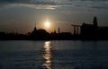 Gorgeous scenic of Thai temple silhouettes and Industrial factory along Chao phraya river over sun at sunrise