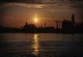 Gorgeous scenic of Thai temple silhouettes and Industrial factory along Chao phraya river over sun at sunrise