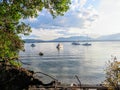 A gorgeous seascape view of a remote bay with boats anchored on the calm still water, in the gulf islands