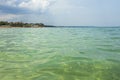 Gorgeous seascape view. Turquoise water surface merging to coast and thunderclouds on background.