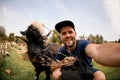 Gorgeous selfie photo of cheerful man next to goat