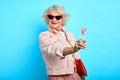 Gorgeous senior woman enjoying eating candy