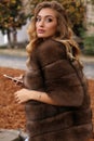 Gorgeous sensual woman with blond hair in luxurious fur coat