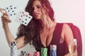 Gorgeous poker girl throwing cards in air