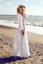 Gorgeous woman with blond curly hair in elegant beach dress Royalty Free Stock Photo