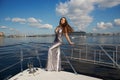 Woman in silver dress at yacht