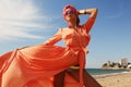 Gorgeous woman in luxurious outfit, posing on summer beach Royalty Free Stock Photo