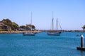 A gorgeous shot of a the boats and yachts docked on the vast blue ocean water in the Dana Point harbor with blue sky, clouds Royalty Free Stock Photo