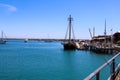 A gorgeous shot of a the boats and yachts docked on the vast blue ocean water in the Dana Point harbor with blue sky, clouds Royalty Free Stock Photo