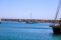 A gorgeous shot of a the boats and yachts docked on the vast blue ocean water in the Dana Point harbor with blue sky, clouds Royalty Free Stock Photo