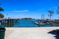 A gorgeous shot of a the boats and yachts docked on the vast blue ocean water in the Dana Point harbor with blue sky, clouds Royalty Free Stock Photo