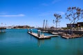 A gorgeous shot of a the boats and yachts docked on the vast blue ocean water in the Dana Point harbor with blue sky, clouds Royalty Free Stock Photo