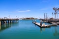 A gorgeous shot of a the boats and yachts docked on the vast blue ocean water in the Dana Point harbor with blue sky, clouds Royalty Free Stock Photo