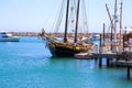 A gorgeous shot of a the boats and yachts docked on the vast blue ocean water in the Dana Point harbor with blue sky, clouds Royalty Free Stock Photo