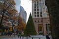 A gorgeous shot of the cityscape in downtown Charlotte with gorgeous autumn trees and black marble waterfall