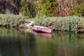 A gorgeous shot of the lush green waters of the canal with colorful boats and lush green trees