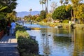 A gorgeous shot of the lush green waters of the canal with colorful boats and lush green trees and plants reflecting off the water Royalty Free Stock Photo