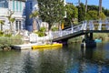 A gorgeous shot of the lush green waters of the canal with colorful boats and lush green trees and plants reflecting off the water Royalty Free Stock Photo