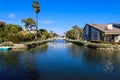 A gorgeous shot of the lush green waters of the canal with colorful boats and lush green trees and plants reflecting off the water Royalty Free Stock Photo