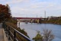 A gorgeous shot of the rippling waters of the Cumberland river with a white tug boat sailing under a red metal bridge Royalty Free Stock Photo