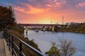 A gorgeous shot of the rippling waters of the Cumberland river with a white tug boat sailing under a red metal bridge Royalty Free Stock Photo