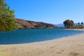 A gorgeous shot of the vast blue water and lush green foliage on the shores of Castaic Lake