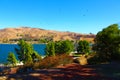 A gorgeous shot of the vast blue water and lush green foliage on the shores of Castaic Lake