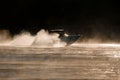 gorgeous side view of motorboat moving fast on the water and splashing drops from the wave around it Royalty Free Stock Photo