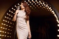 Gorgeous singer woman in with retro microphone on restaurant stage