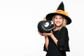 Gorgeous smiling Halloween Witch holding a Jack o Lantern. Beautiful young woman in witches hat and costume holding pumpkin. Royalty Free Stock Photo