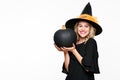 Gorgeous smiling Halloween Witch holding large black pumpkin. Portrait of a beautiful young woman wearing witch hat. Halloween. Royalty Free Stock Photo
