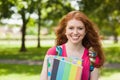 Gorgeous smiling student holding notebooks Royalty Free Stock Photo