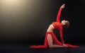 Gorgeous sporty woman in red clothing doing yoga exercise Royalty Free Stock Photo